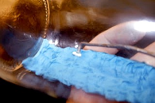 Putting the clay "sea" in the bottle